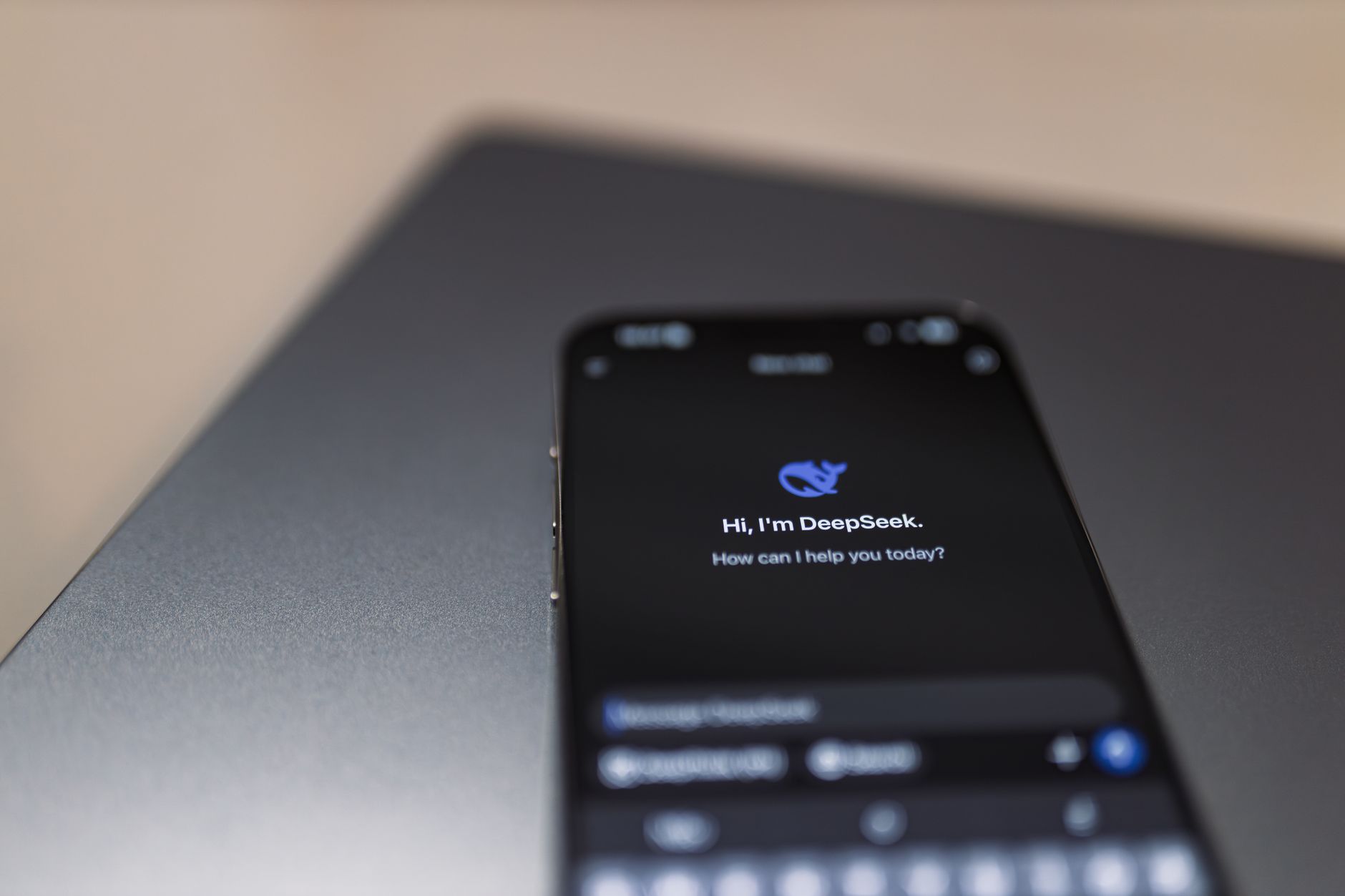 chatgpt on whatsapp now supports image inputs and voice messages - Close-up of a smartphone with AI assistant interface on screen over a laptop.