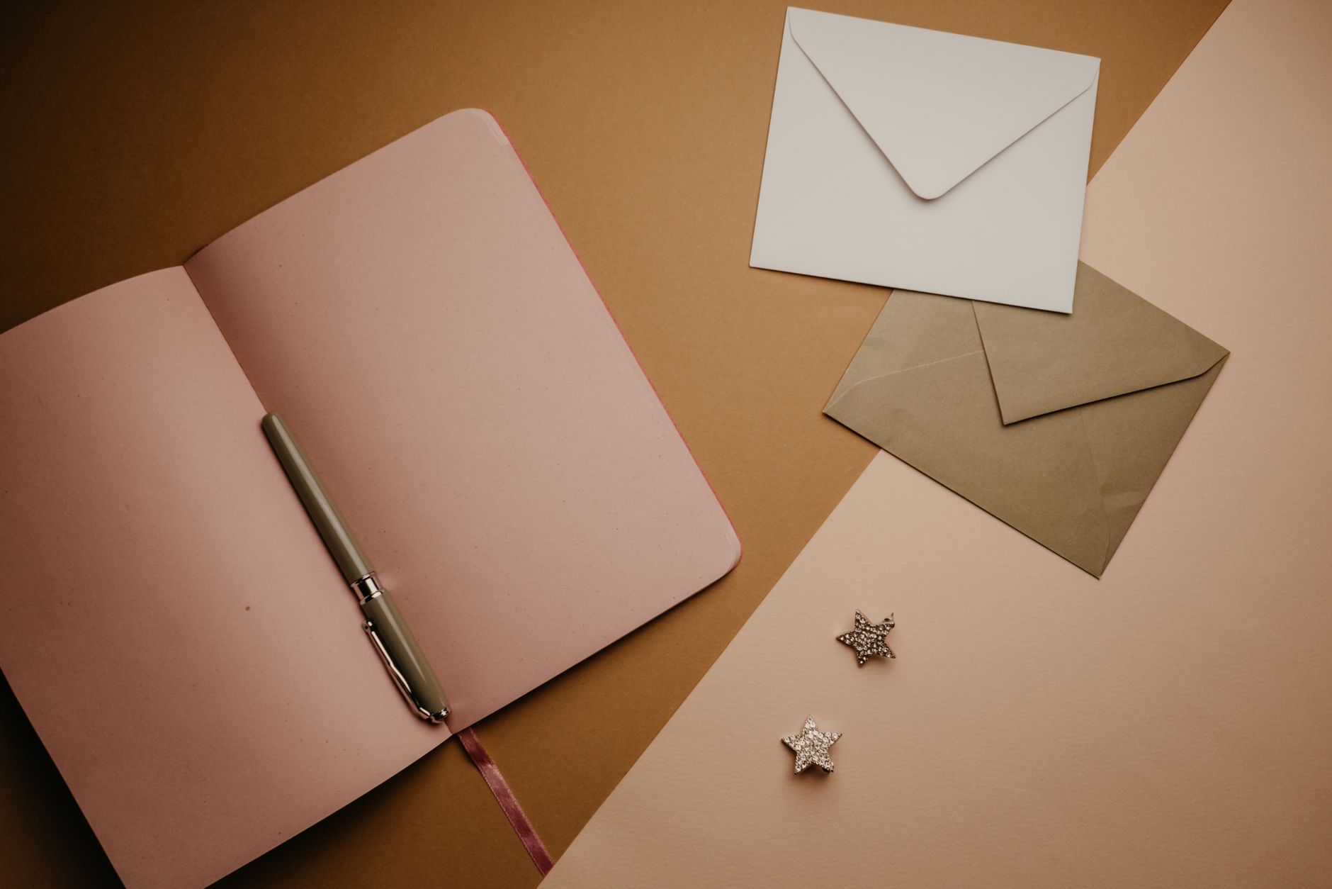 how to write a good message - A stylish flat lay featuring an open notebook, envelopes, and a pen, perfect for stationery enthusiasts.