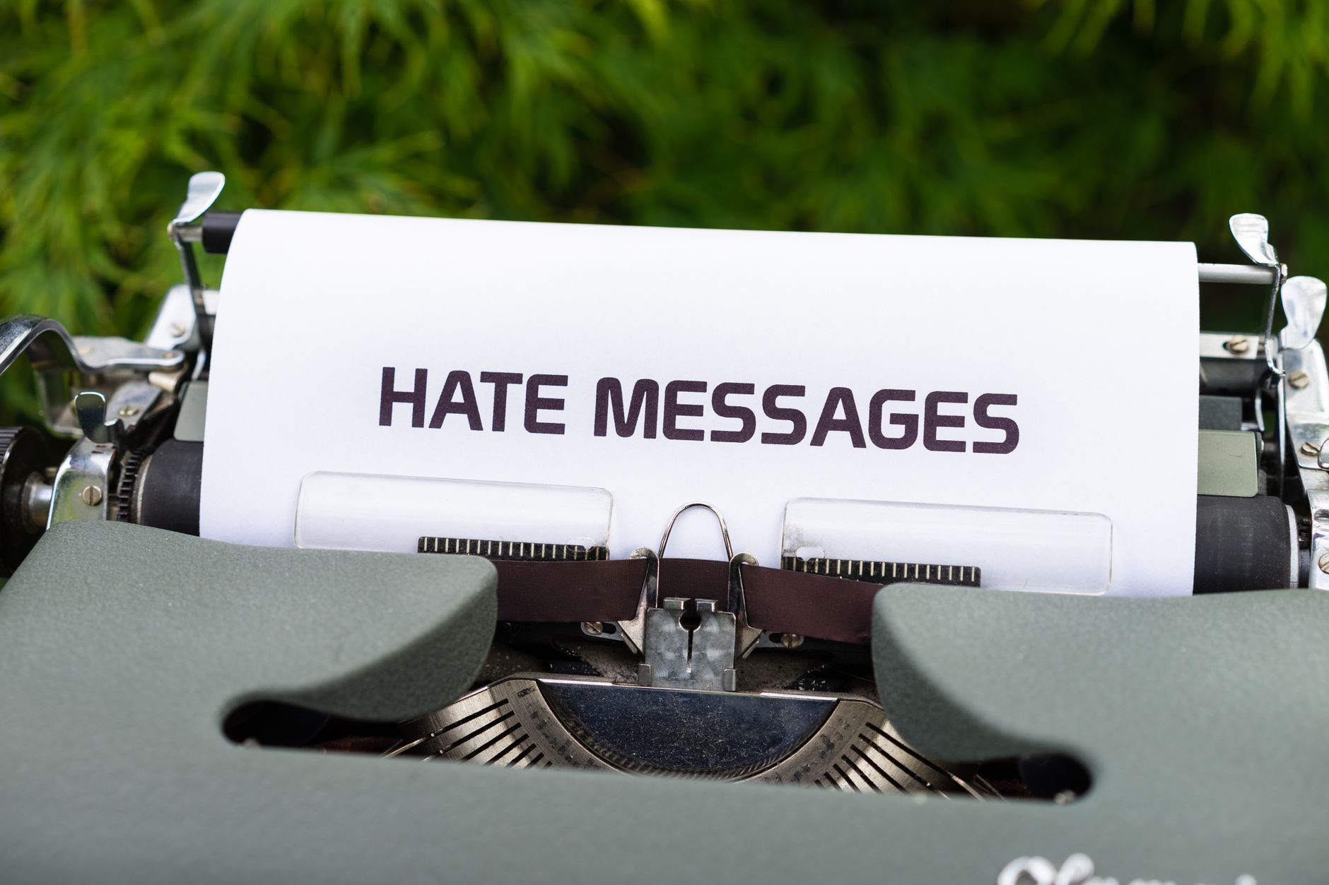 how to write a good message - Close-up of a vintage typewriter with paper displaying 'Hate Messages', exploring themes of communication and negativity.