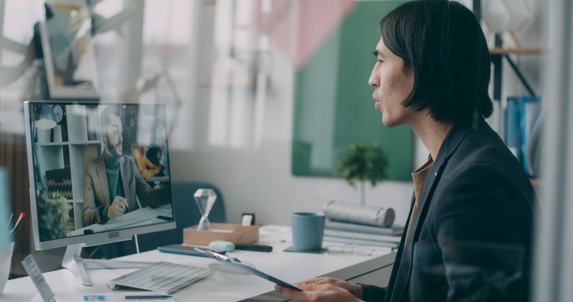 Message Support Strategies for Remote Teams - A professional engaged in a video conference in a modern office setting.