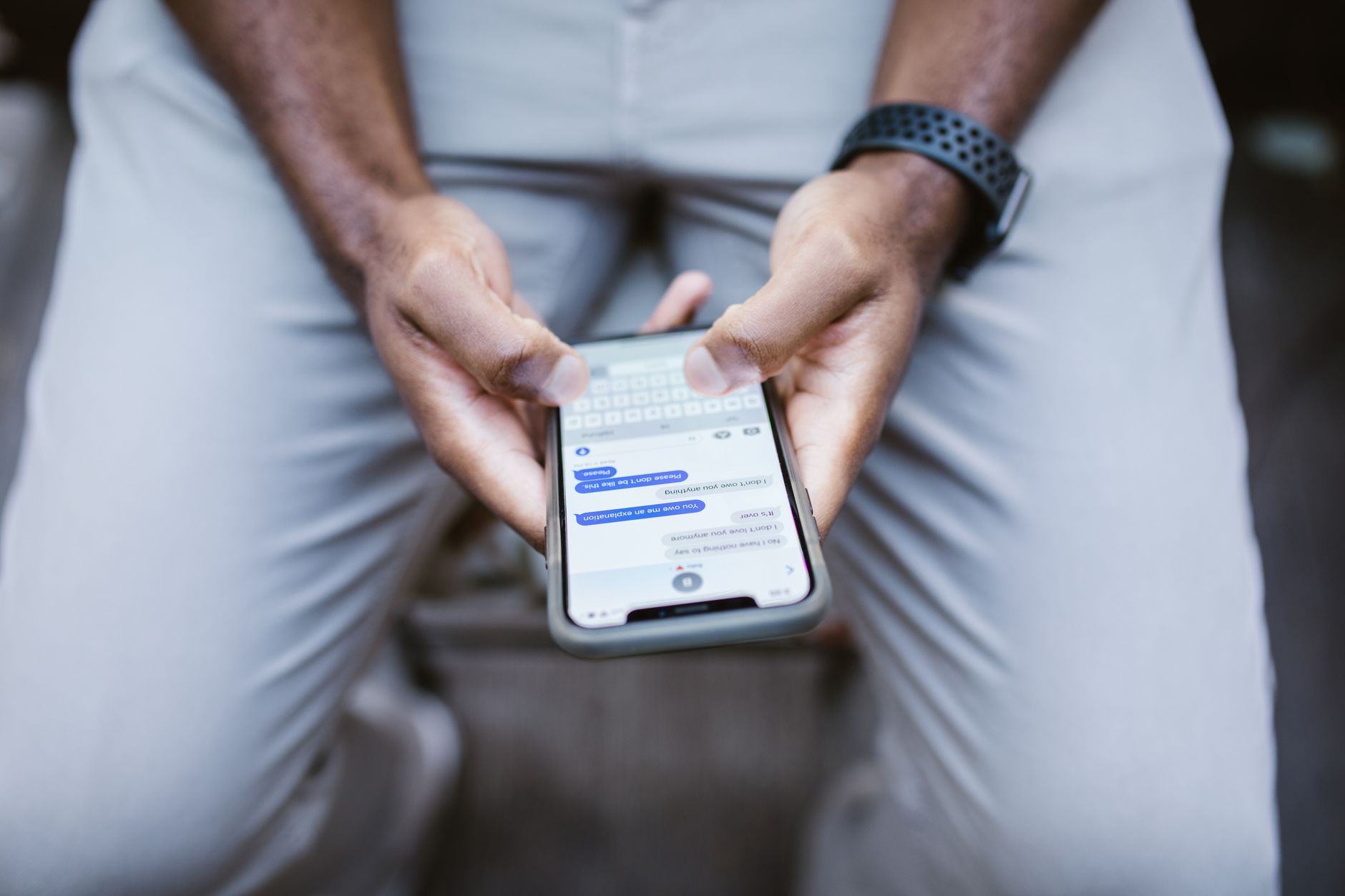 nonprofit organizations text messaging supporters fundraising - Close-up view of a man texting on a smartphone, capturing communication in action.