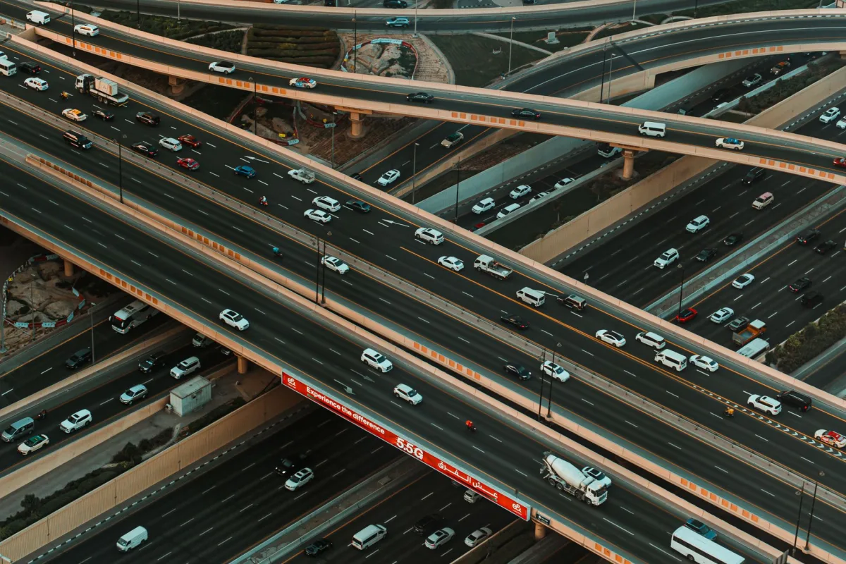 High-angle shot of a busy highway interchange in Dubai, capturing the complexity of urban traffic. High-angle shot of a busy highway interchange in Dubai, capturing the complexity of urban traffic.