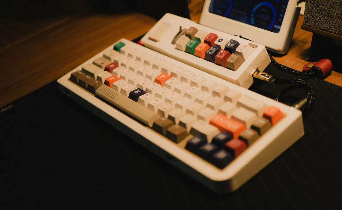 Vintage mechanical keyboard with colorful keys on a wooden desk, evoking a classic gaming setup. Vintage mechanical keyboard with colorful keys on a wooden desk, evoking a classic gaming setup.