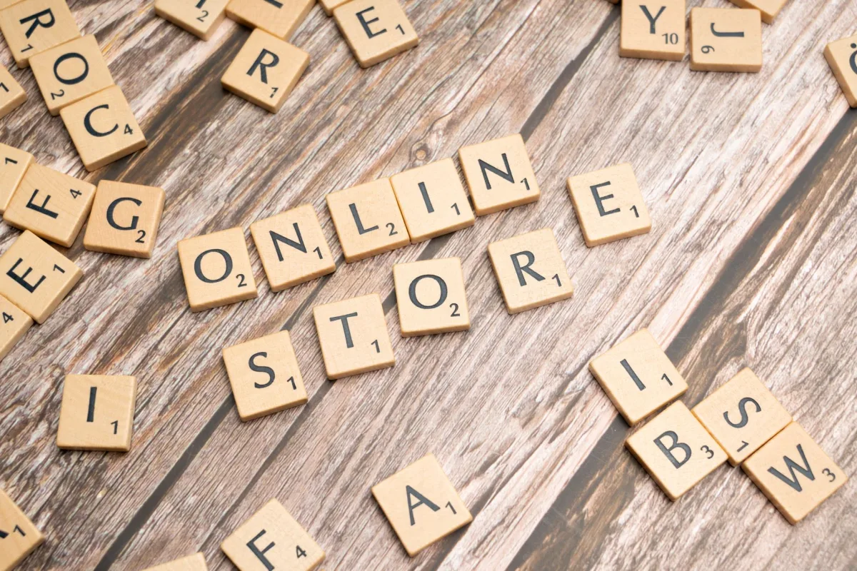 Scrabble tiles spelling 'online store' on a rustic wooden background. Scrabble tiles spelling 'online store' on a rustic wooden background.