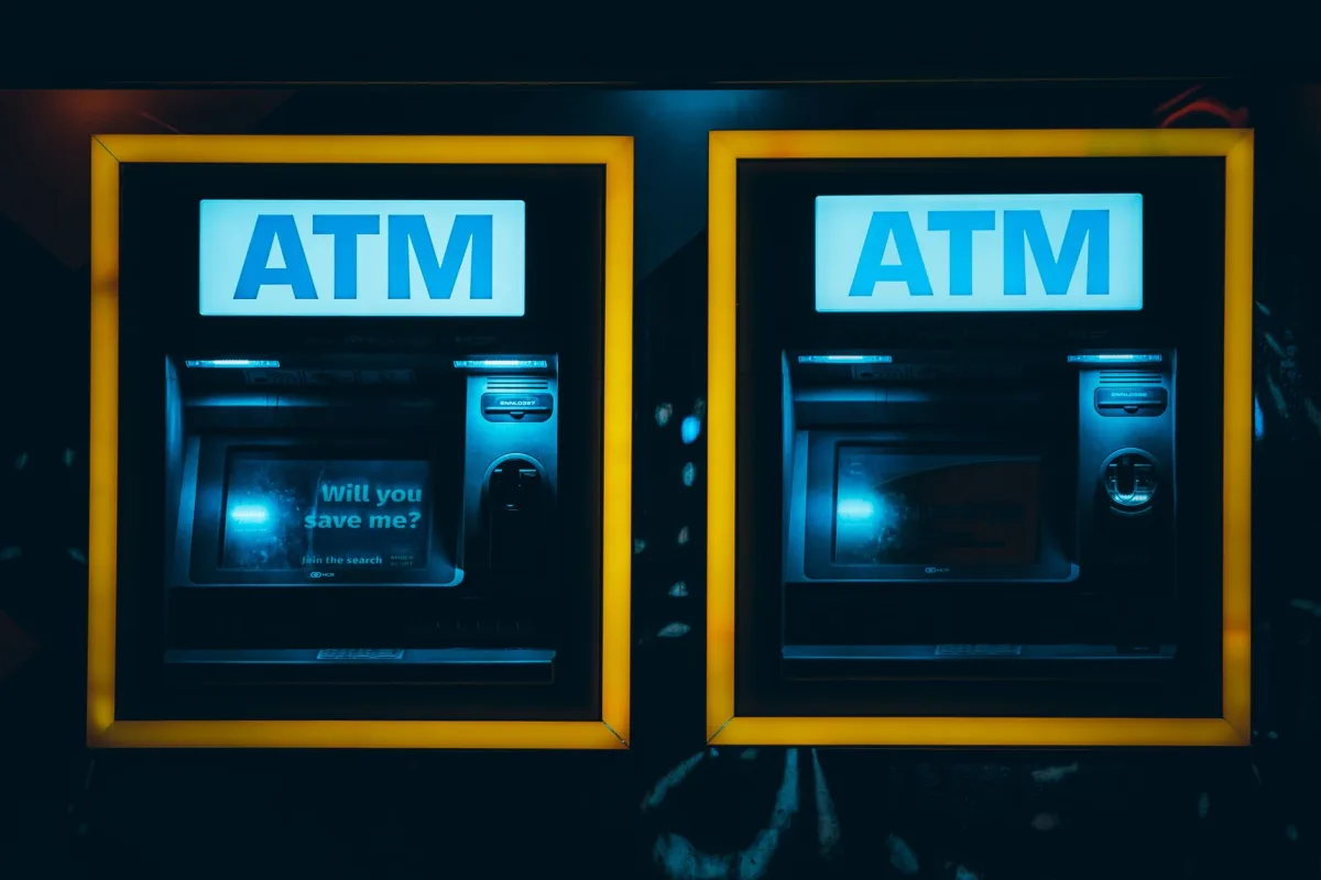 Two illuminated ATMs in a dark urban setting in Rotterdam, Netherlands. Two illuminated ATMs in a dark urban setting in Rotterdam, Netherlands.