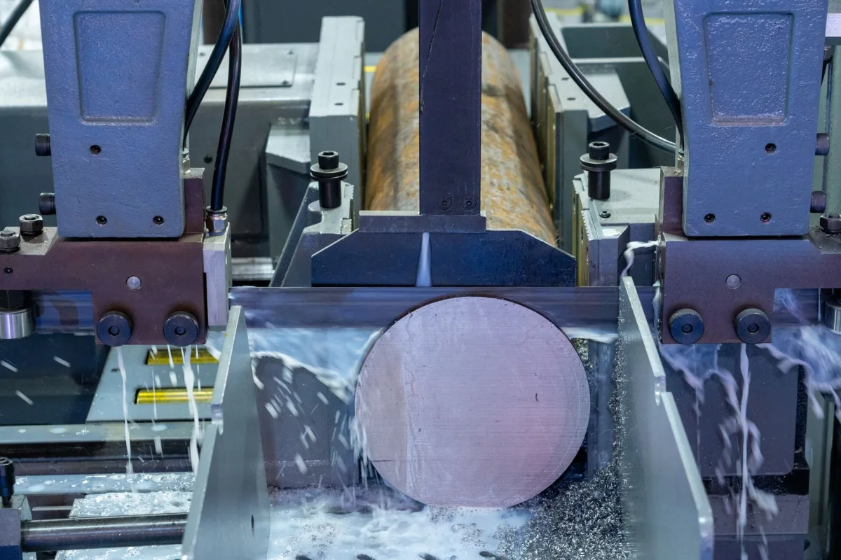 Close-up of an industrial machine cutting a metal rod with precision. Close-up of an industrial machine cutting a metal rod with precision.