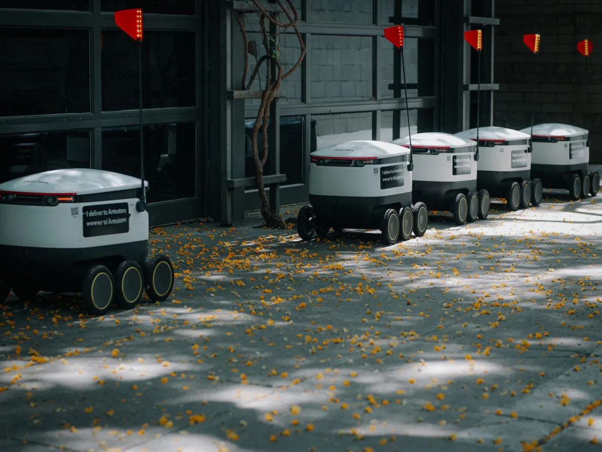 Autonomous robots lined up outdoors showcasing modern transportation technology innovations. Autonomous robots lined up outdoors showcasing modern transportation technology innovations.