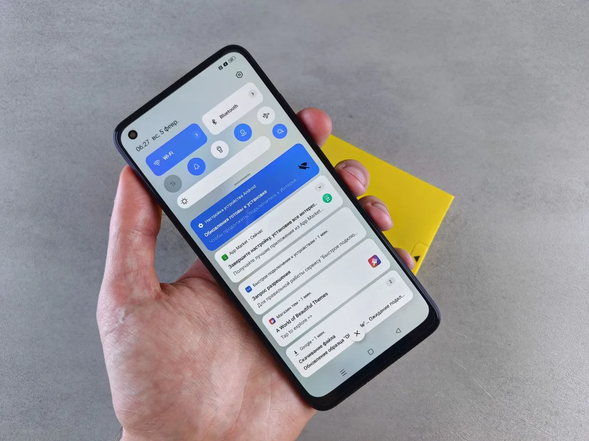 A close-up of a hand holding a smartphone displaying multiple highlighting modern technology. A close-up of a hand holding a smartphone displaying multiple highlighting modern technology.
