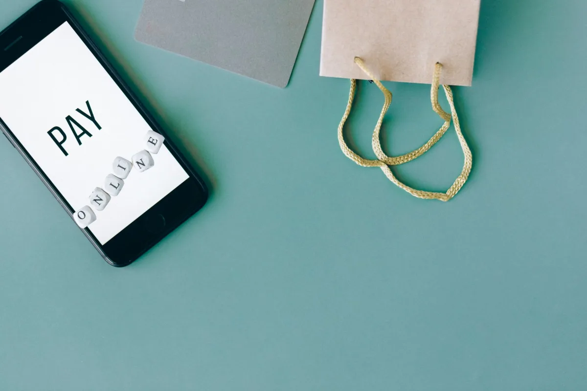 Illustration of online payment with smartphone, credit card, and shopping bag on mint background. Illustration of online payment with smartphone, credit card, and shopping bag on mint background.
