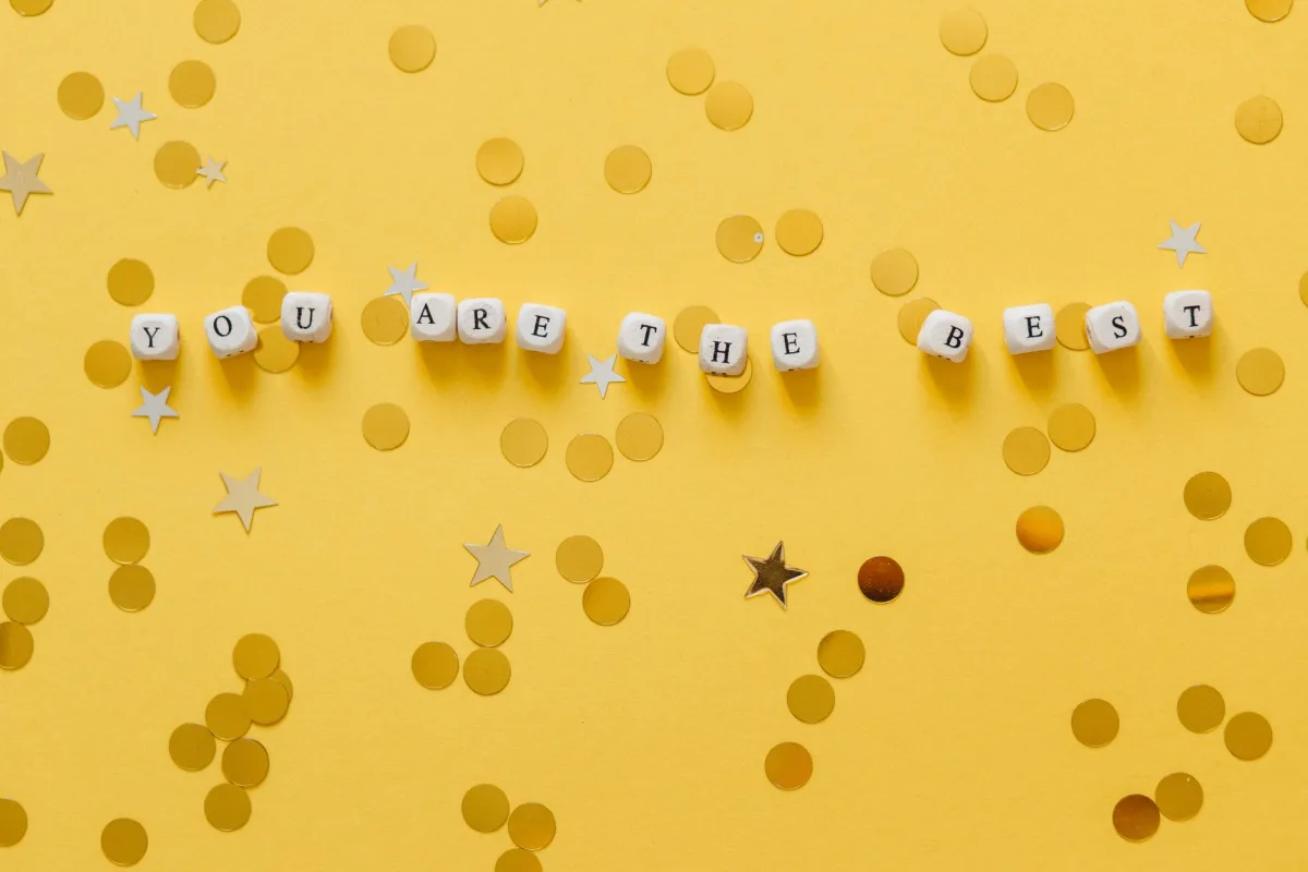 Inspirational message 'You Are The Best' with confetti on a yellow background.