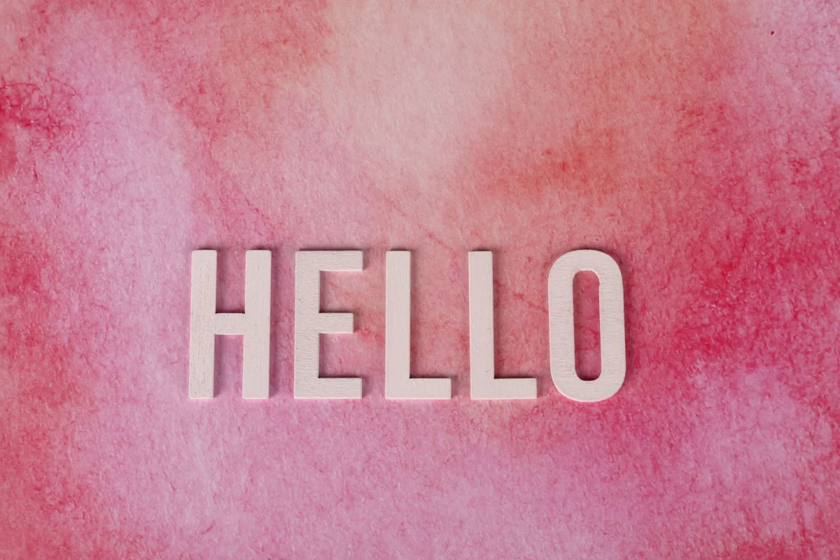 Pink textured background with bold white 'HELLO' text for greetings and