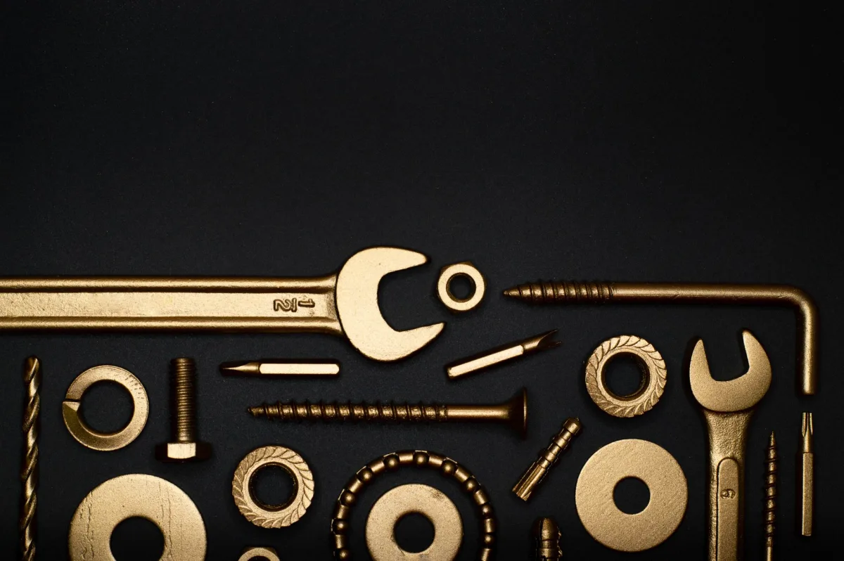 Artistic arrangement of gold tools on a black background, offering ample copy space. Artistic arrangement of gold tools on a black background, offering ample copy space.