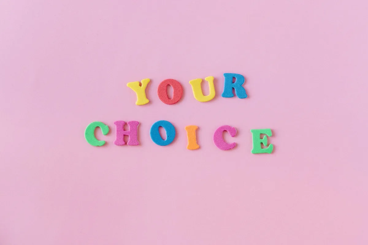 Vibrant foam letters spelling 'YOUR CHOICE' on a pink background. Perfect for concepts of decision-making. Vibrant foam letters spelling 'YOUR CHOICE' on a pink background. Perfect for concepts of decision-making.
