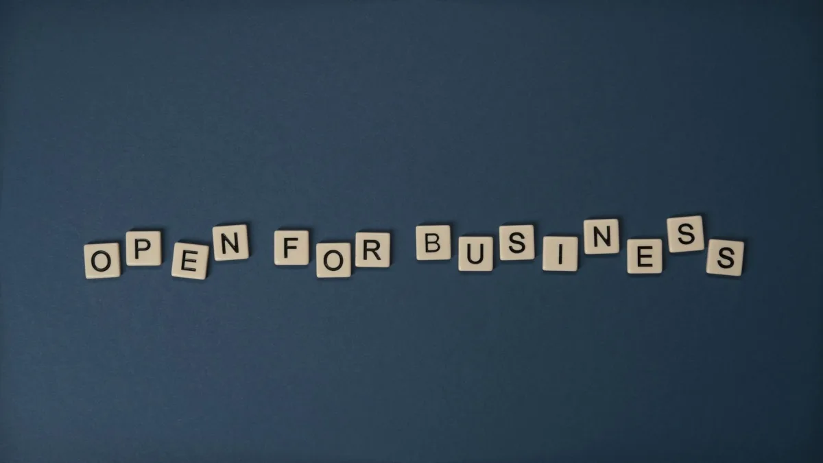 Creative flat lay with 'Open for Business' text on dark blue surface. Conceptual design ideal for business themes. Creative flat lay with 'Open for Business' text on dark blue surface. Conceptual design ideal for business themes.