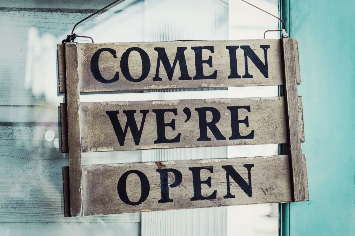 Close-up of a rustic open sign welcoming customers. Perfect for business or commerce themes. Close-up of a rustic open sign welcoming customers. Perfect for business or commerce themes.