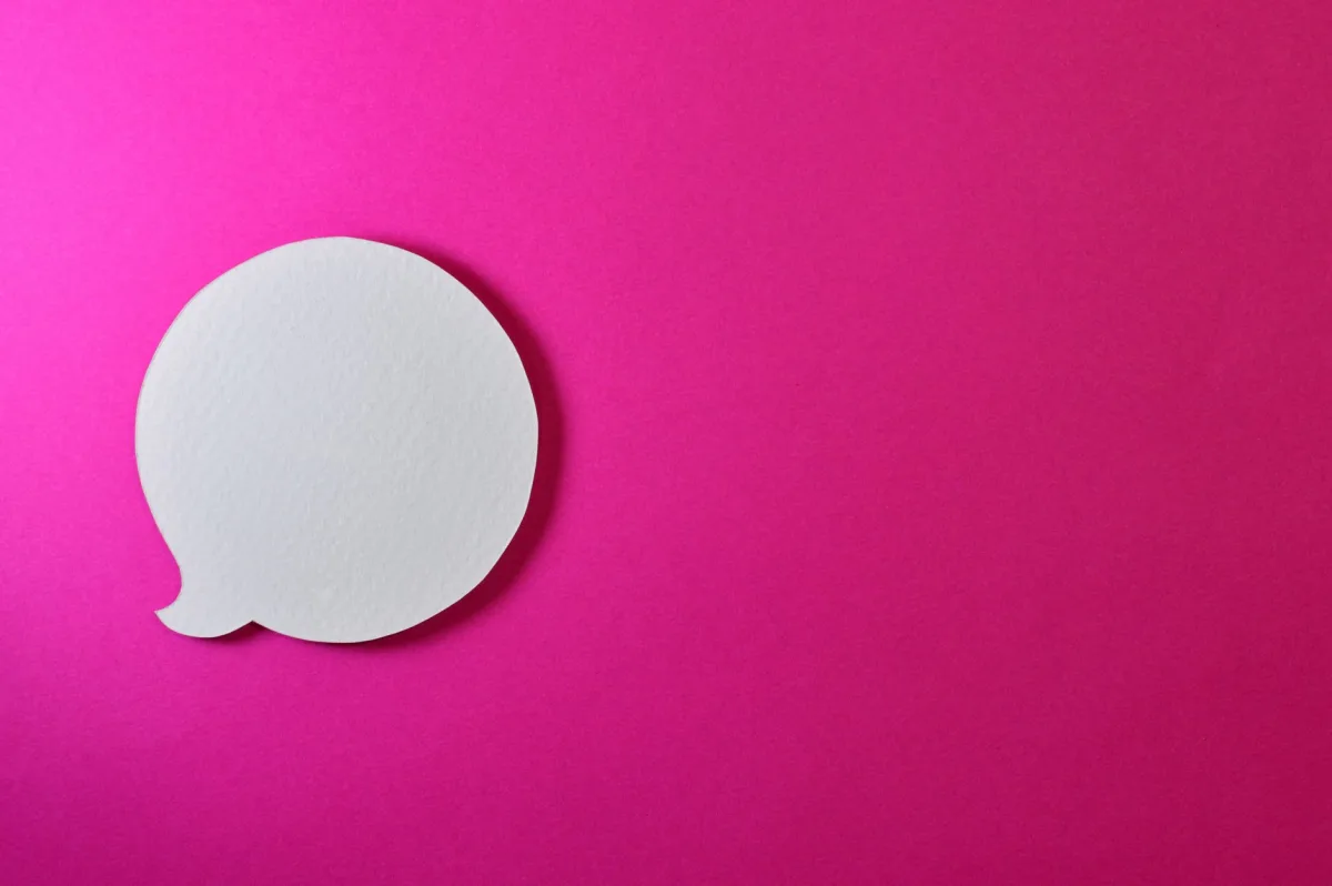 Minimalist pink background with a white speech bubble for creative design projects. Minimalist pink background with a white speech bubble for creative design projects.