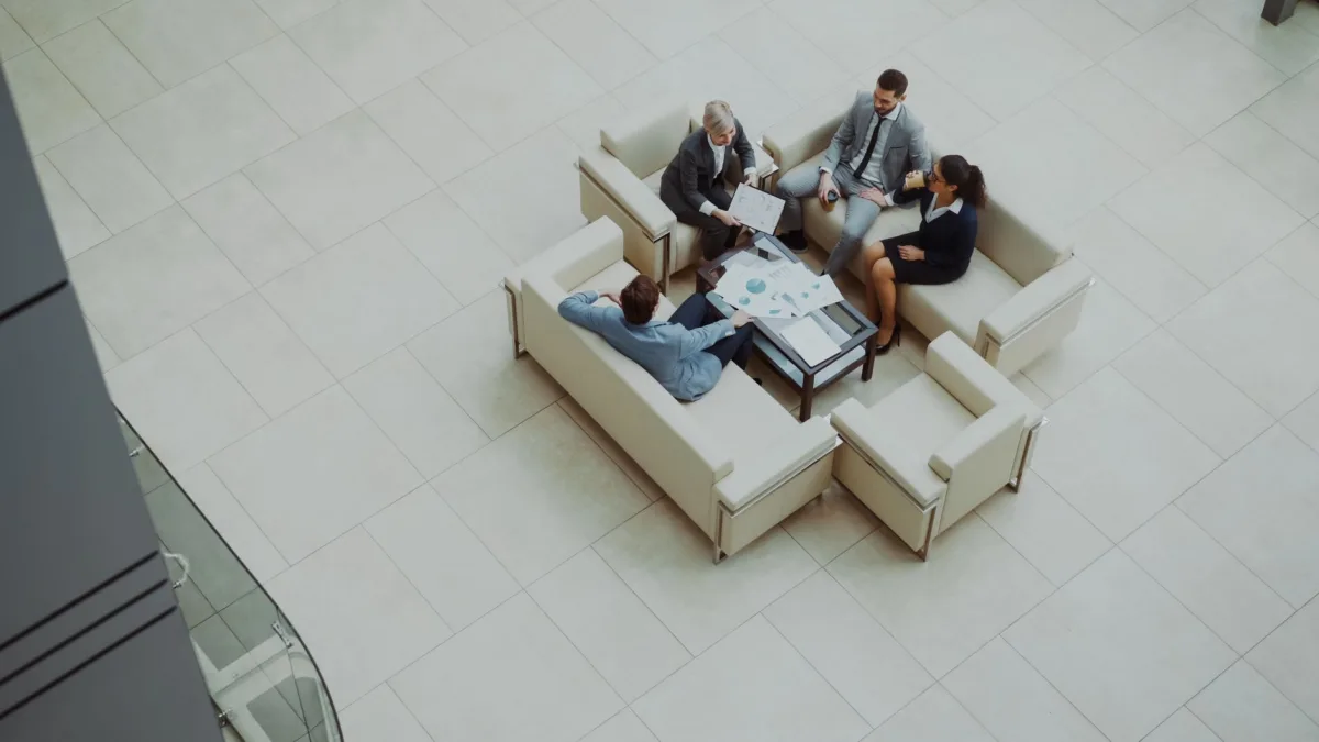 Aerial view of a group business meeting in a modern office setting. Aerial view of a group business meeting in a modern office setting.