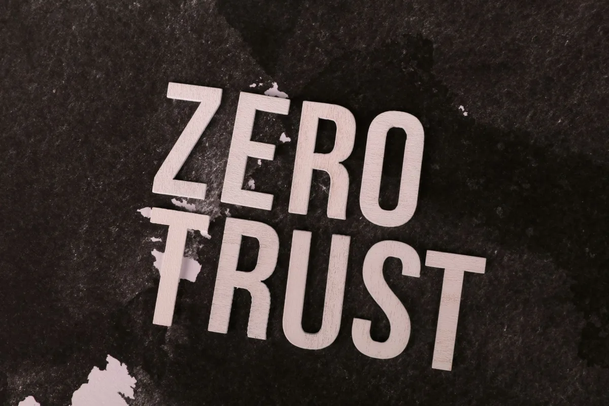 Bold 'Zero Trust' text against a textured black background, symbolizing cybersecurity.