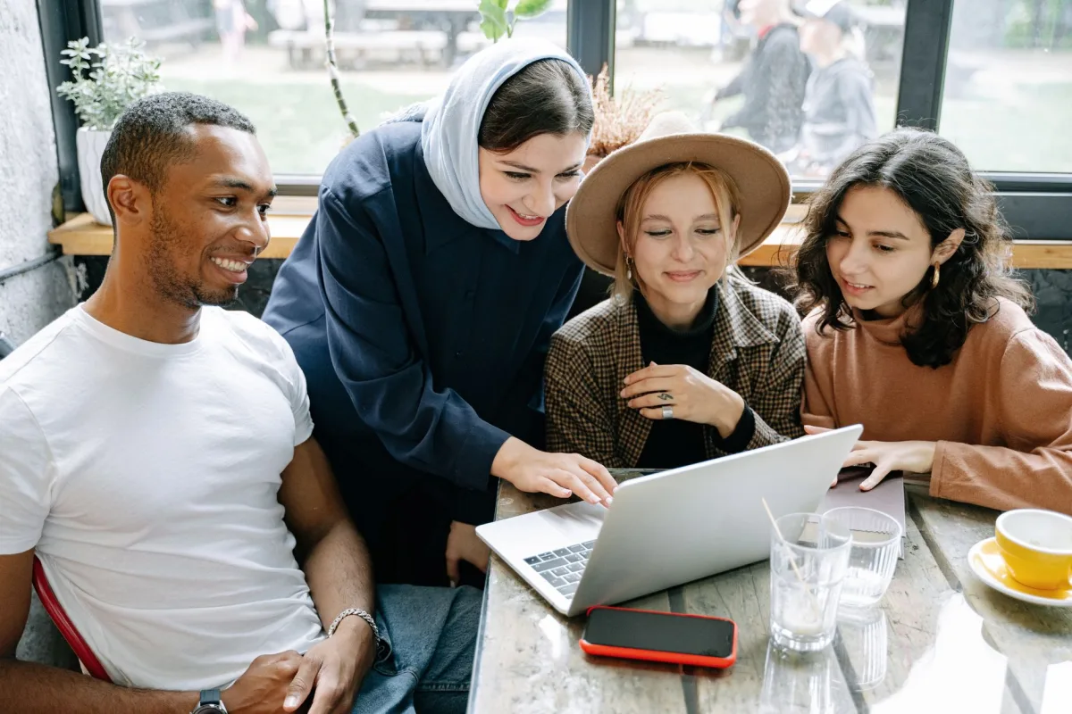 A diverse group of professionals engaging in a collaborative project in a modern workspace. A diverse group of professionals engaging in a collaborative project in a modern workspace.