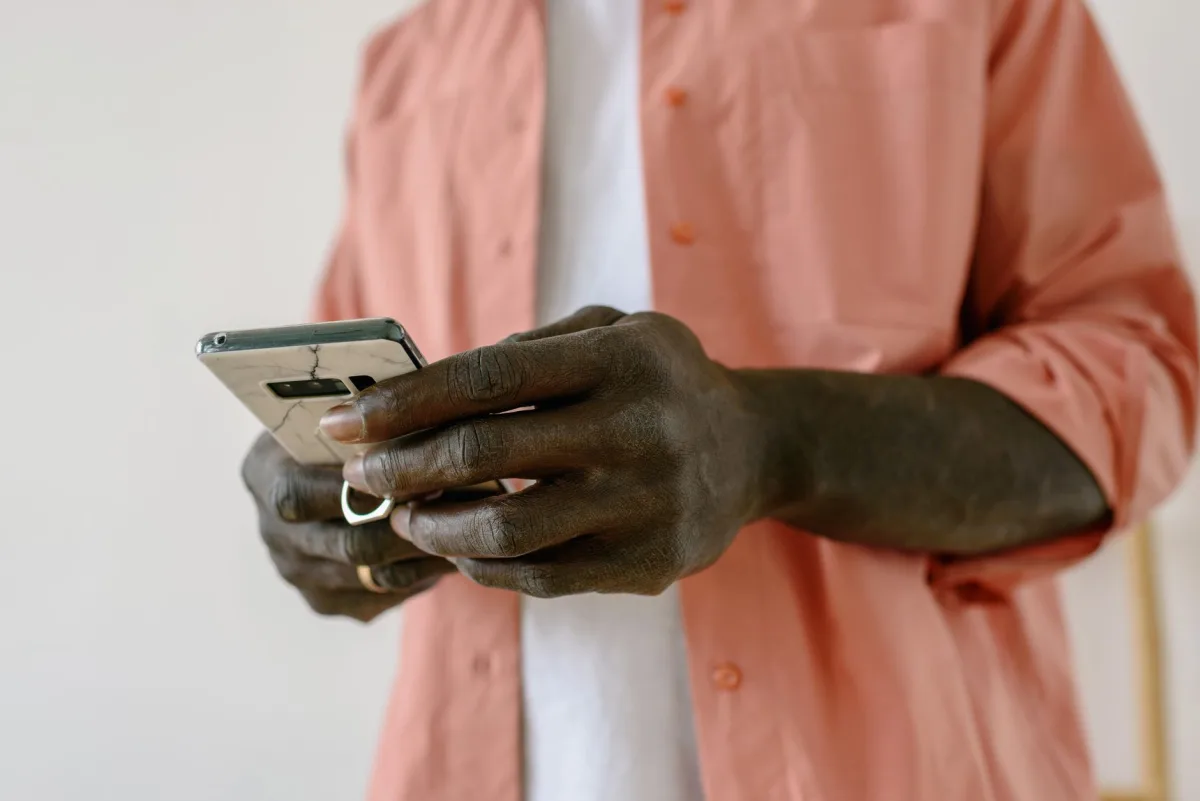 A close-up view of a person using a smartphone indoors, focusing on connectivity and technology. A close-up view of a person using a smartphone indoors, focusing on connectivity and technology.