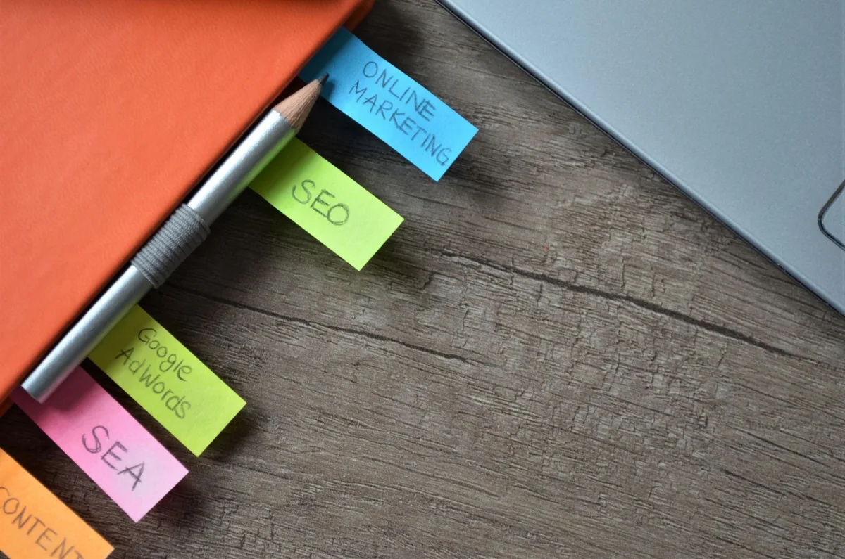 Close-up of SEO strategy planner with colorful sticky notes and a pencil on a notebook. Close-up of SEO strategy planner with colorful sticky notes and a pencil on a notebook.