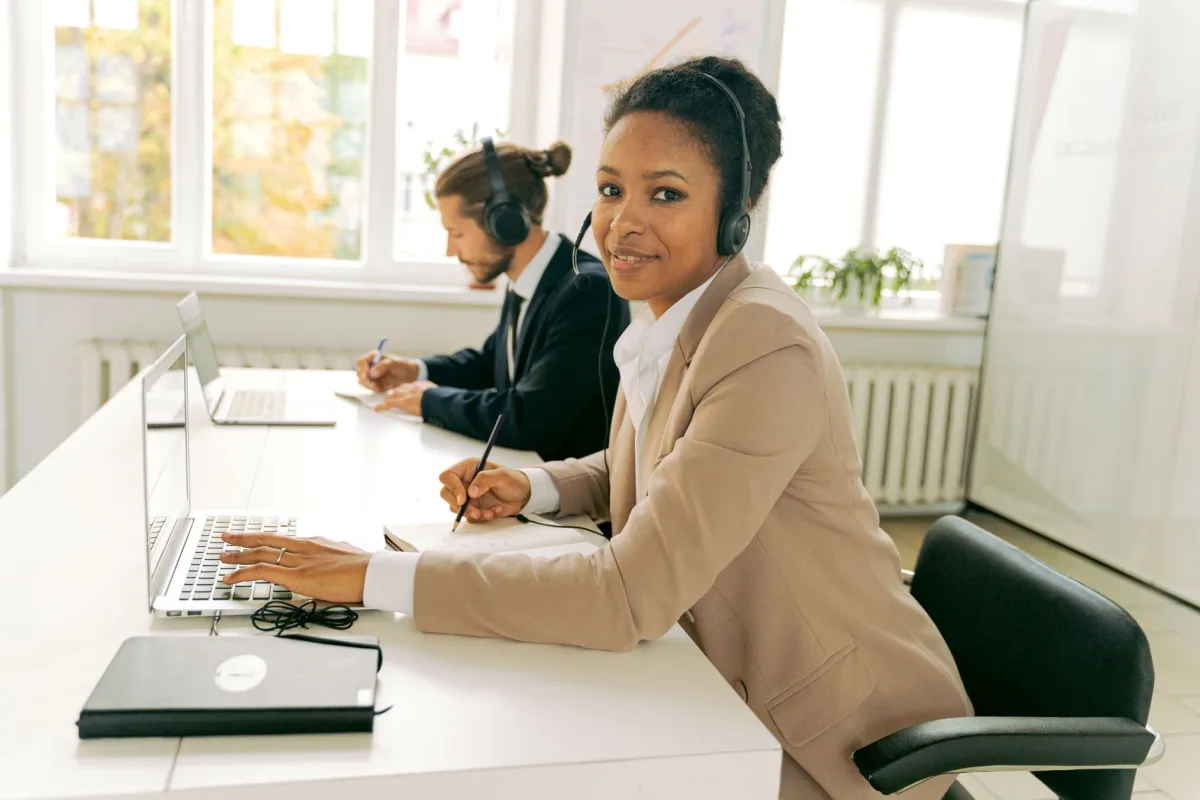 Friendly customer support team working in a bright, modern office.