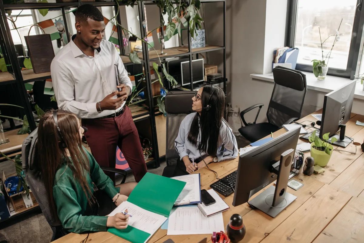 A team of diverse workers collaborating in a modern office setting. A team of diverse workers collaborating in a modern office setting.