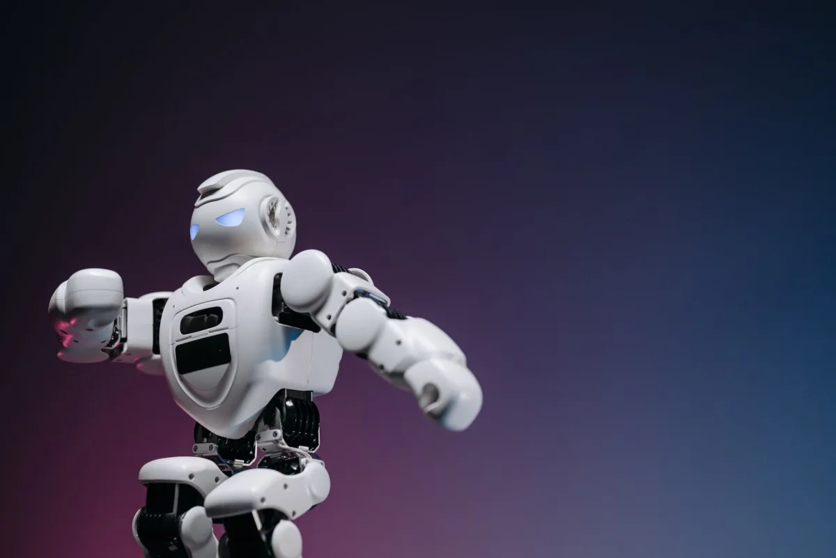 Close-up of a futuristic robotic toy against a gradient background, symbolizing innovation and technology.