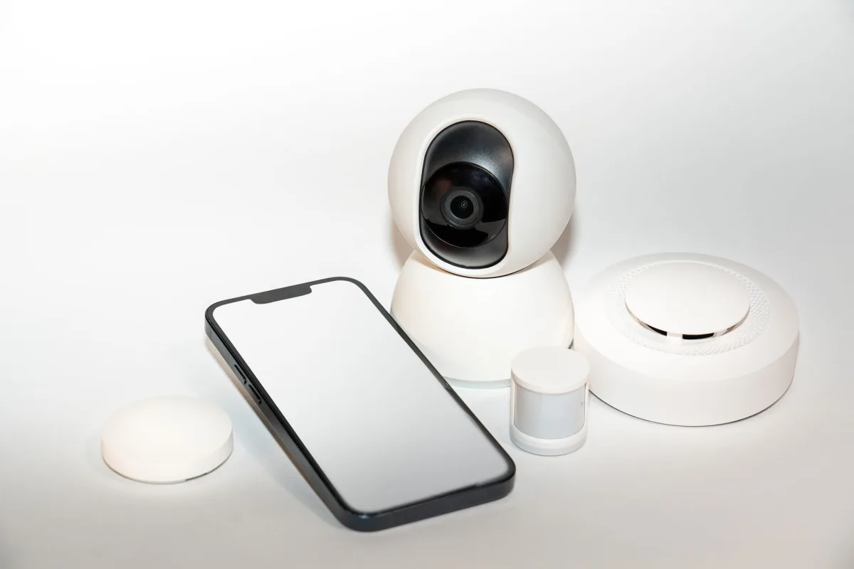 Collection home security gadgets with a smartphone display.