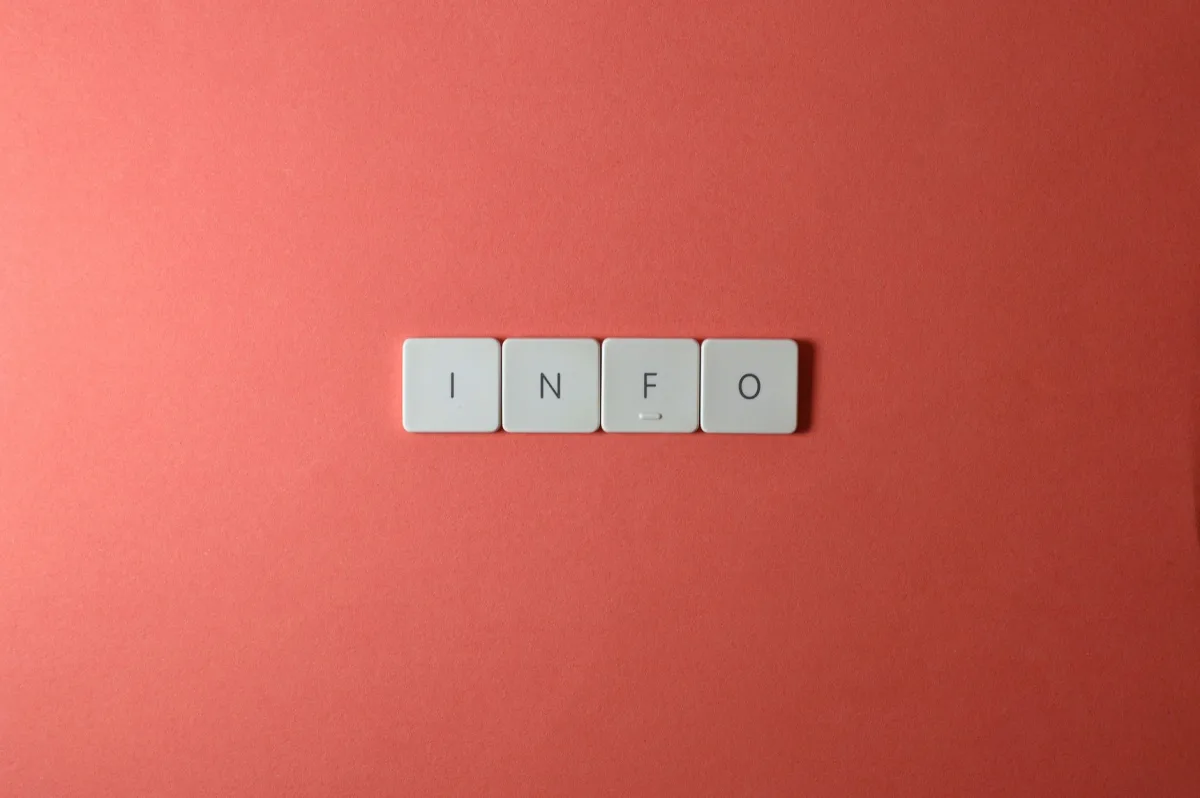 Close-up of keyboard buttons spelling 'INFO' on a minimal red background, ideal for tech and communication themes. Close-up of keyboard buttons spelling 'INFO' on a minimal red background, ideal for tech and communication themes.