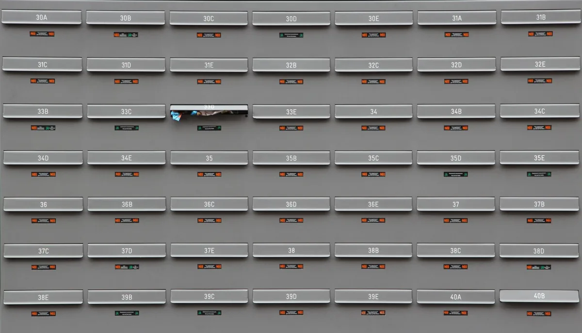 A grid of grey mailboxes with number labels showing an organized system.