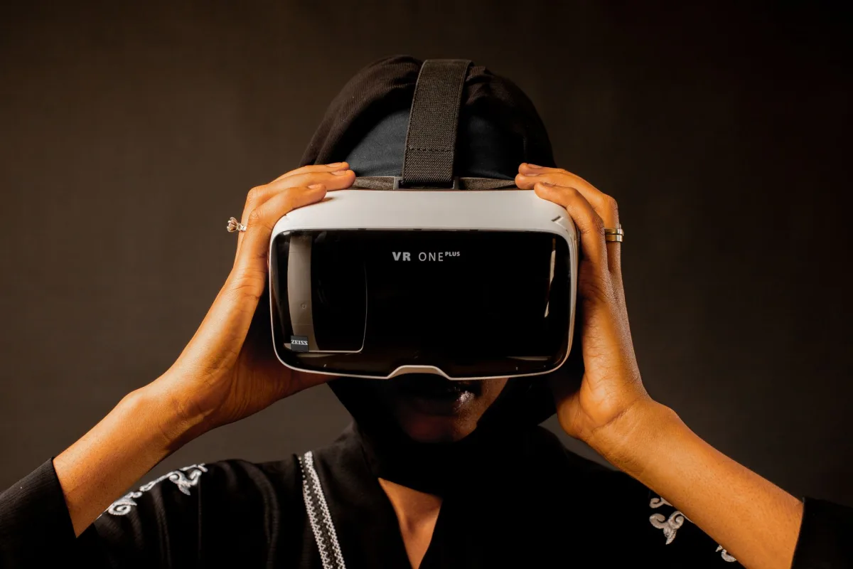 Woman using a headset, immersed in a virtual reality experience. Woman using a headset, immersed in a virtual reality experience.