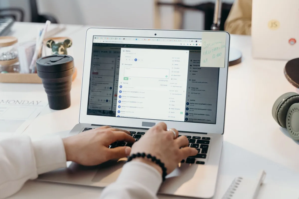A person typing on a laptop in a bright, modern office setting, showing productivity and technology. A person typing on a laptop in a bright, modern office setting, showing productivity and technology.