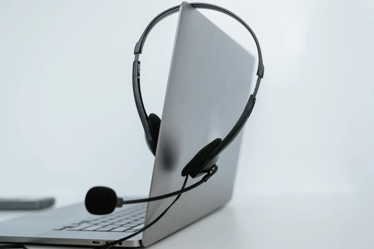 Close-up of a laptop with a headset, symbolizing remote work or online communication. Close-up of a laptop with a headset, symbolizing remote work or online communication.