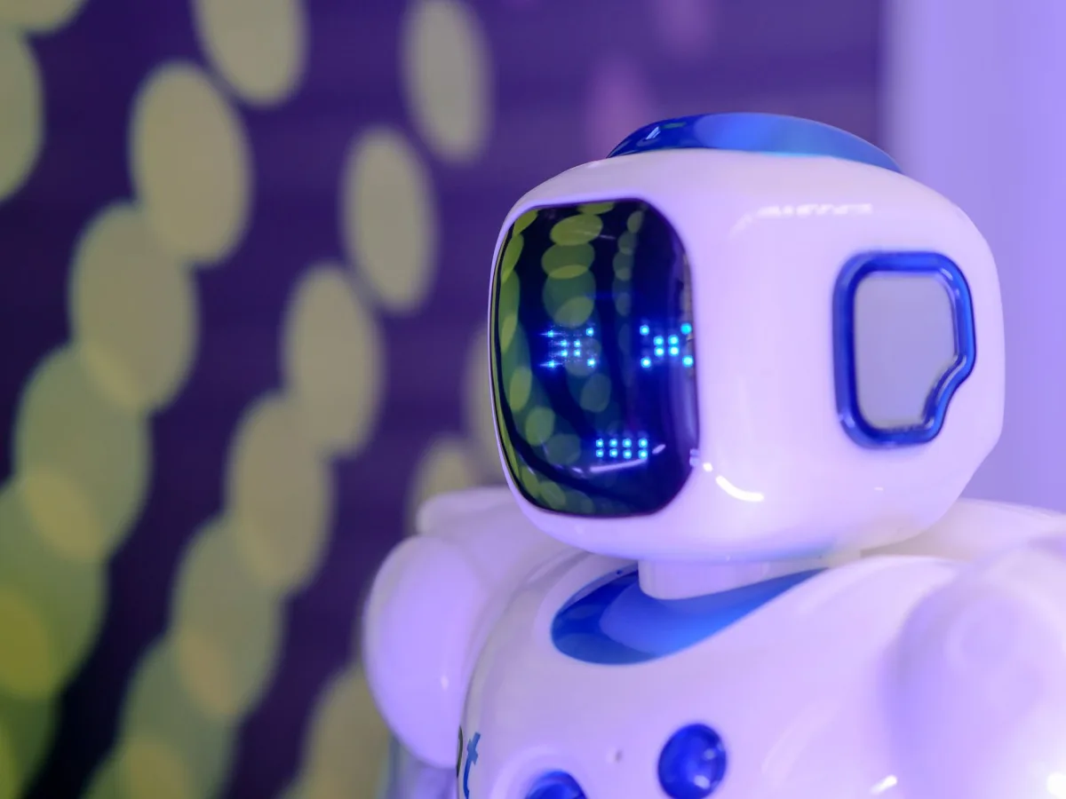 Close-up of a futuristic humanoid robot with a luminescent display in a modern setting. Close-up of a futuristic humanoid robot with a luminescent display in a modern setting.
