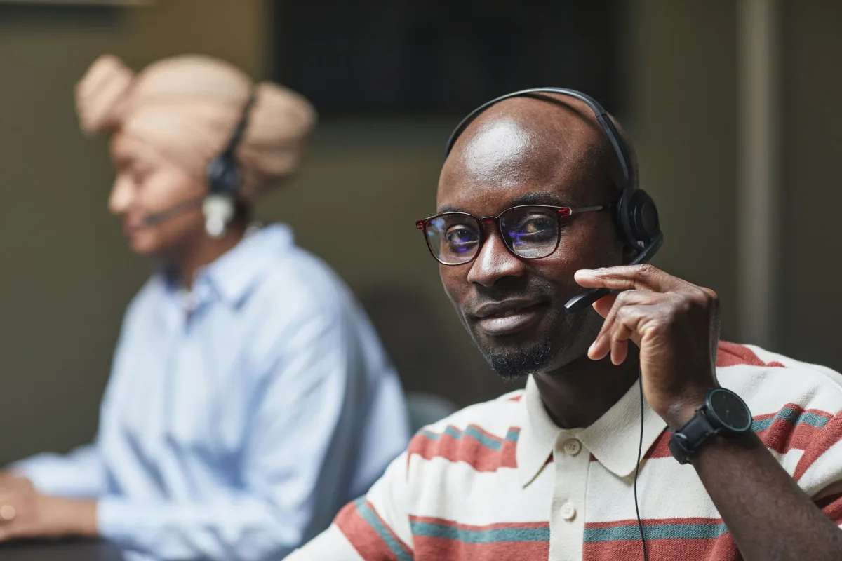 Friendly representatives wearing headsets, working in an office setting.