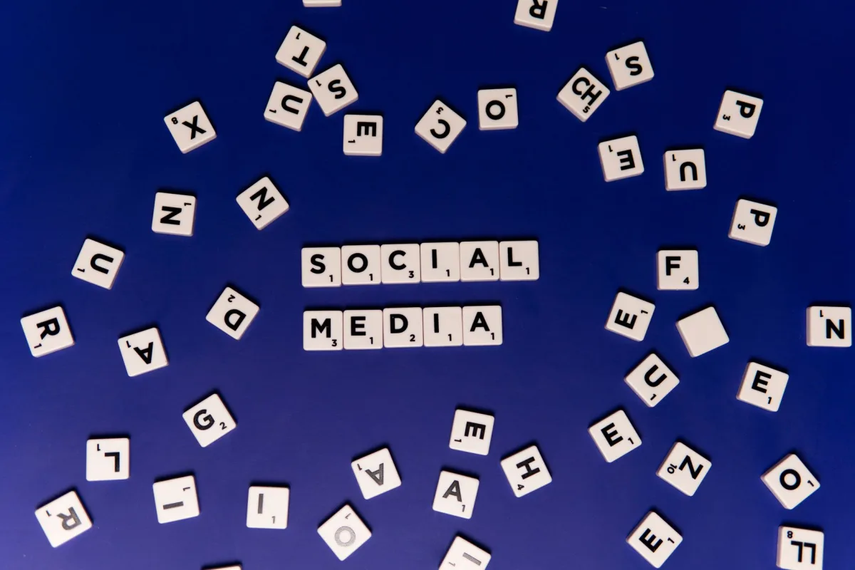 Scrabble tiles spelling 'Social Media' on a blue background, ideal for marketing themes. Scrabble tiles spelling 'Social Media' on a blue background, ideal for marketing themes.