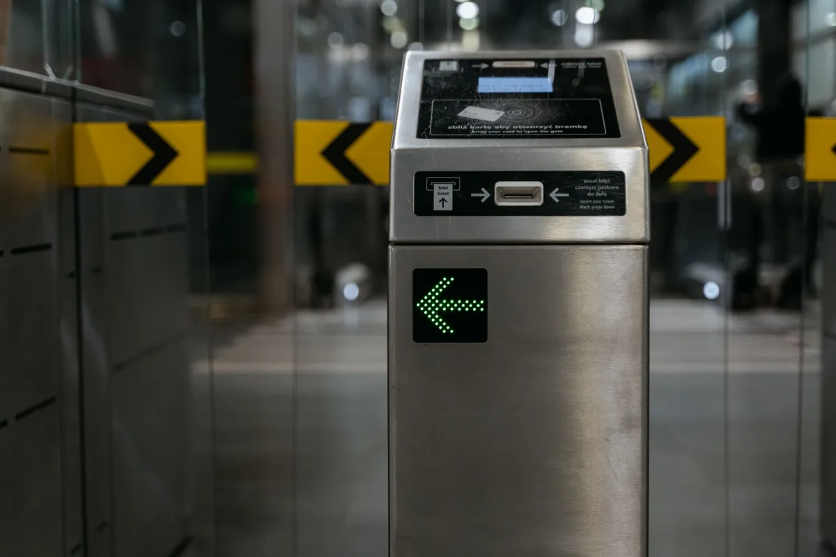 A modern ticket gate with an illuminated arrow for access control in transit A modern ticket gate with an illuminated arrow for access control in transit
