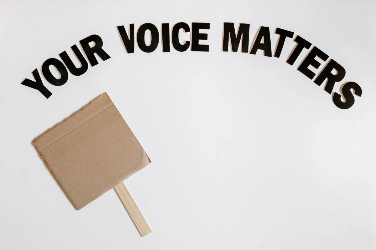 Cardboard protest sign with text 'Your Voice Matters' emphasizes empowerment and advocacy.
