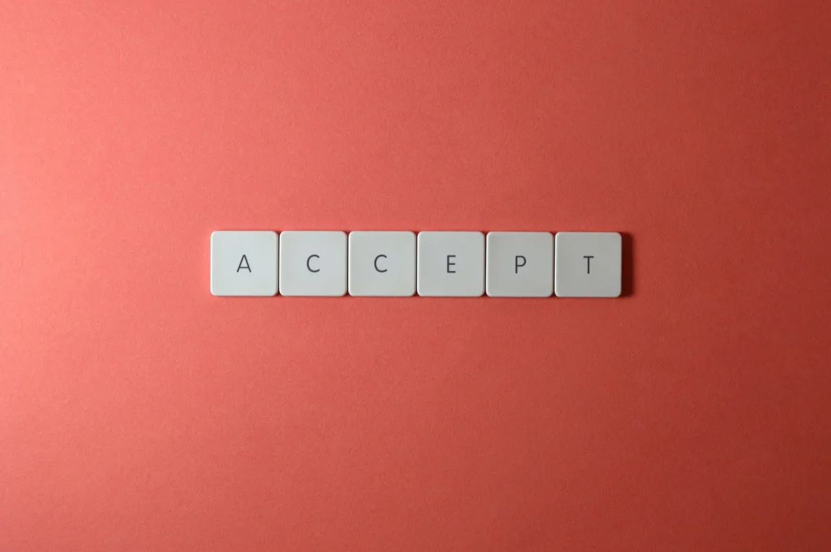 Close-up of keyboard keys spelling 'ACCEPT' on a red background, creating a minimalist and modern design. Close-up of keyboard keys spelling 'ACCEPT' on a red background, creating a minimalist and modern design.