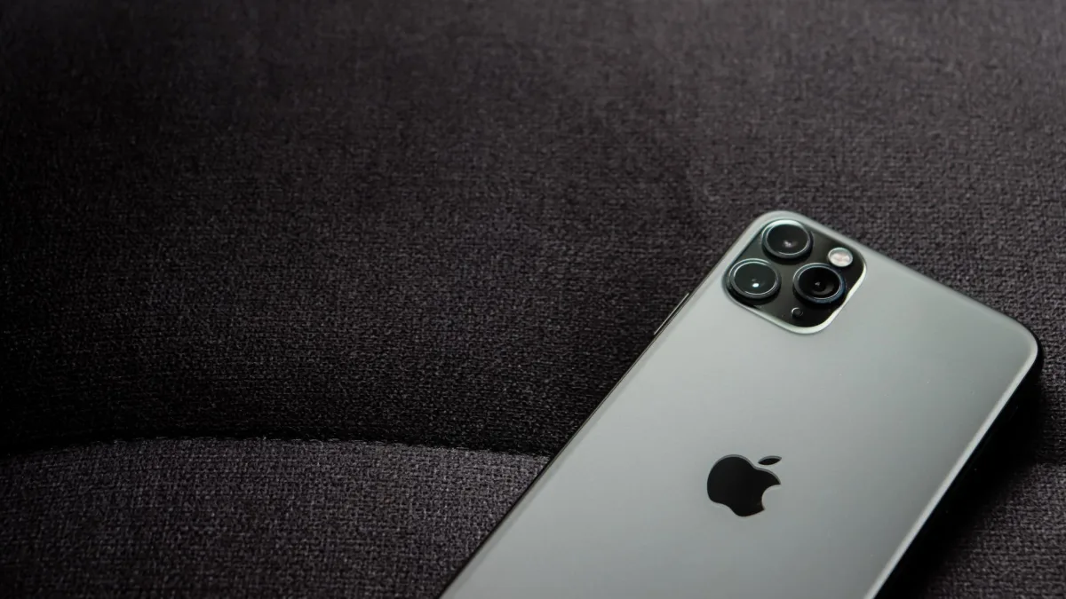 Close-up of a smartphone highlighting its modern design on a dark background. Close-up of a smartphone highlighting its modern design on a dark background.