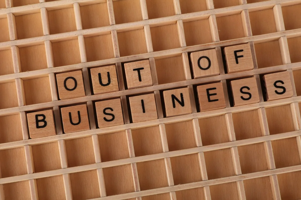 Wooden blocks spelling 'Out of Business', conveying closure or financial difficulties. Wooden blocks spelling 'Out of Business', conveying closure or financial difficulties.