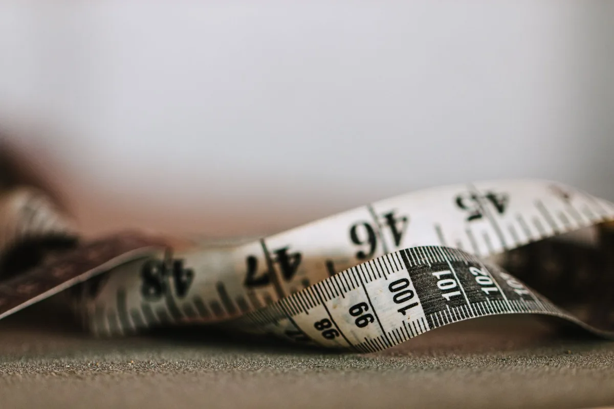 Artistic shallow focus image a measuring tape showing numbers and units.