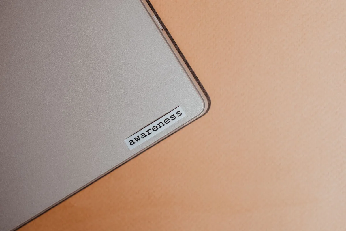 Close-up of a beige laptop with an sticker, promoting mindfulness and digital organization. Close-up of a beige laptop with an sticker, promoting mindfulness and digital organization.