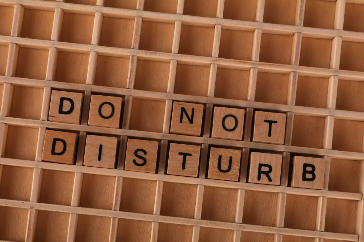 Wooden blocks spelling 'Do Not Disturb' arranged in a grid pattern.