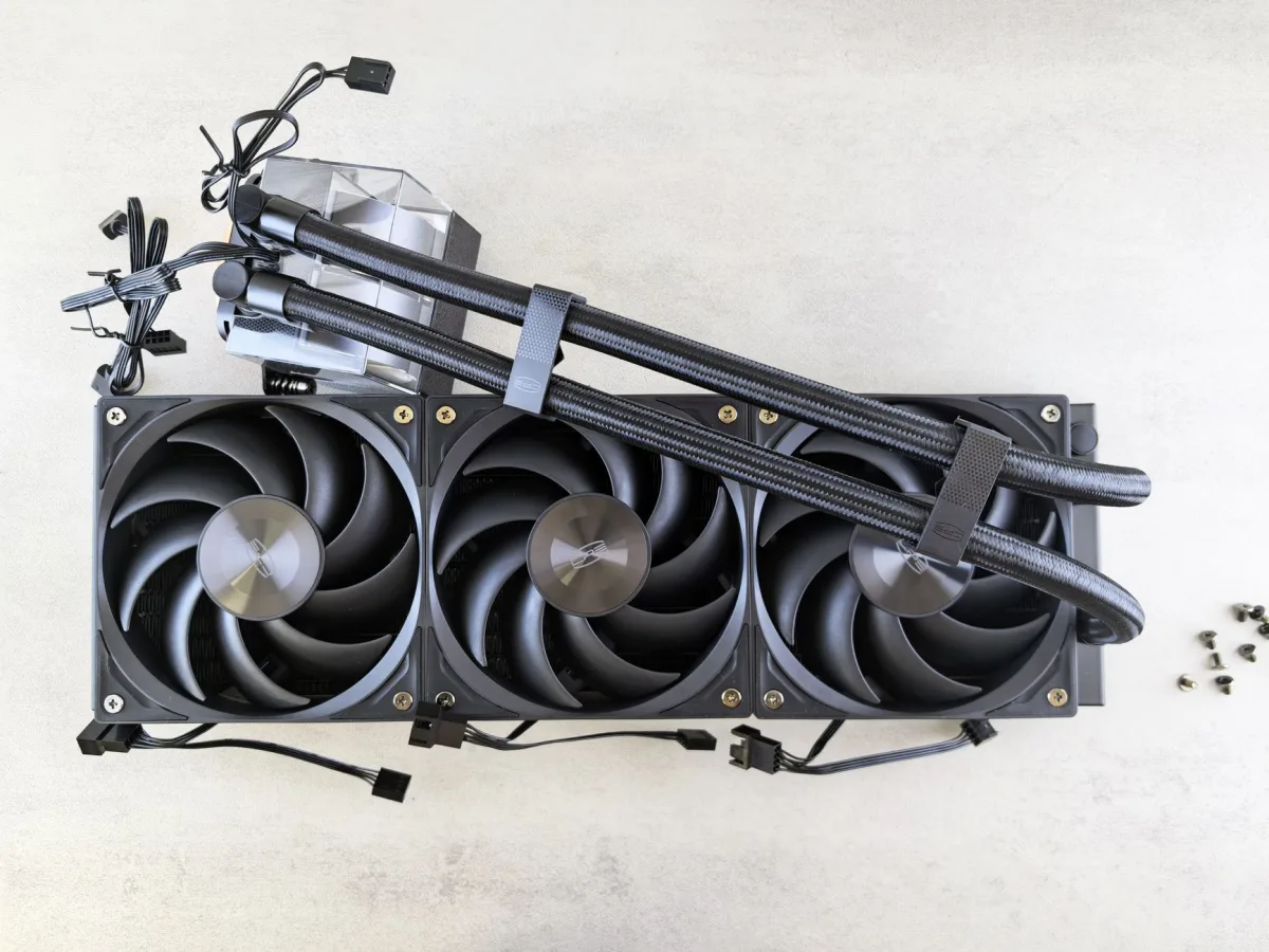 Top view of a CPU liquid cooling system with fans and cables on a light surface.