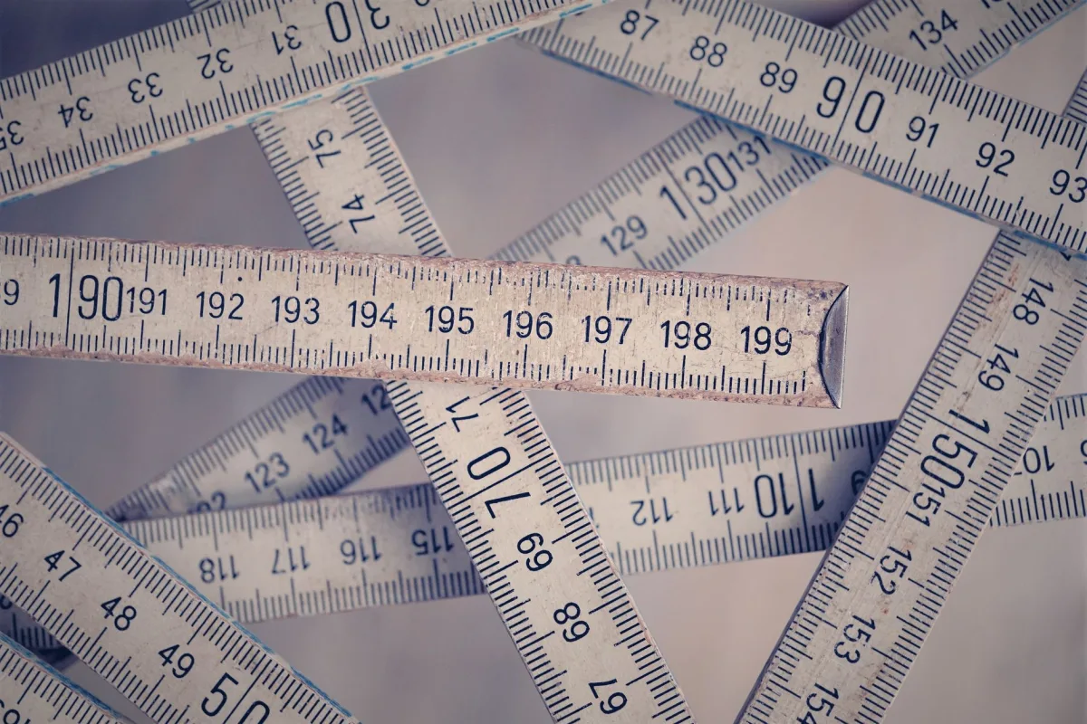 A collection of vintage folding rulers centimeters on a neutral background. A collection of vintage folding rulers centimeters on a neutral background.