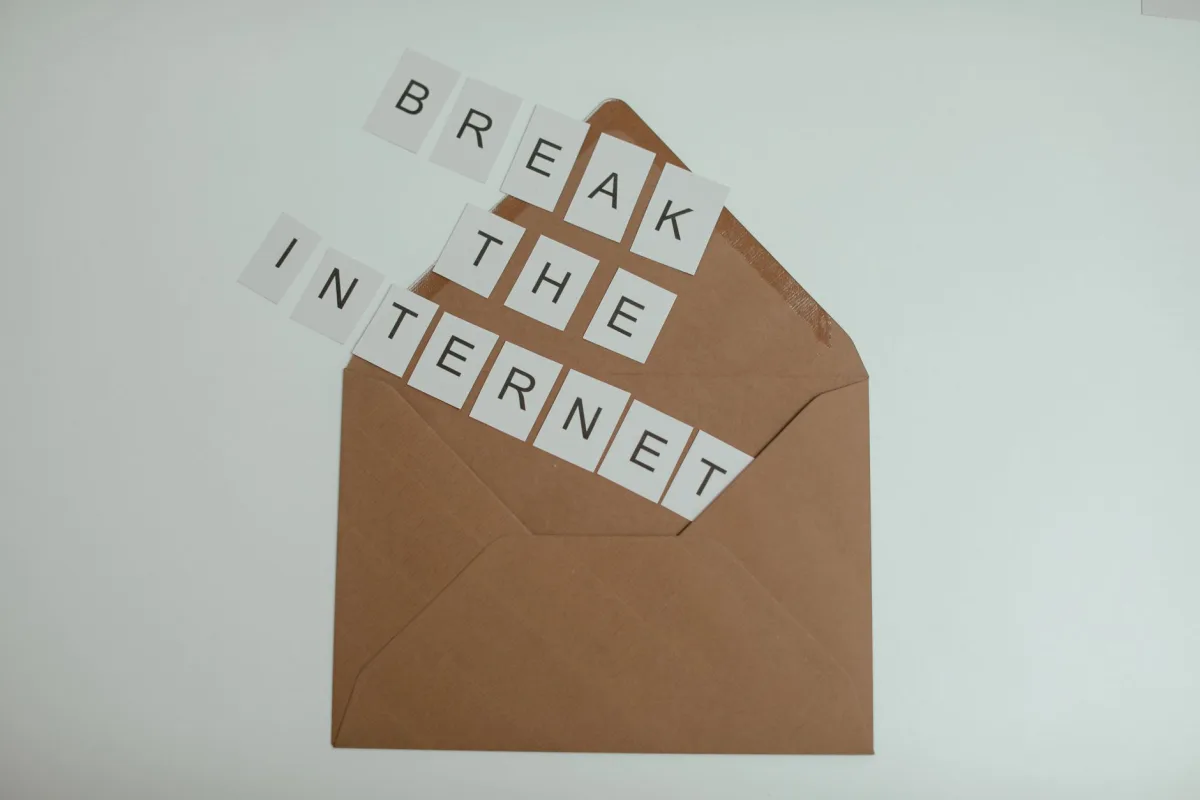 Brown envelope with tiles spelling 'Break the Internet' creates a conceptual and modern theme. Brown envelope with tiles spelling 'Break the Internet' creates a conceptual and modern theme.