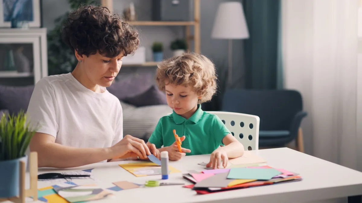 Mother and young child together indoors, fostering creativity and bonding. Mother and young child together indoors, fostering creativity and bonding.