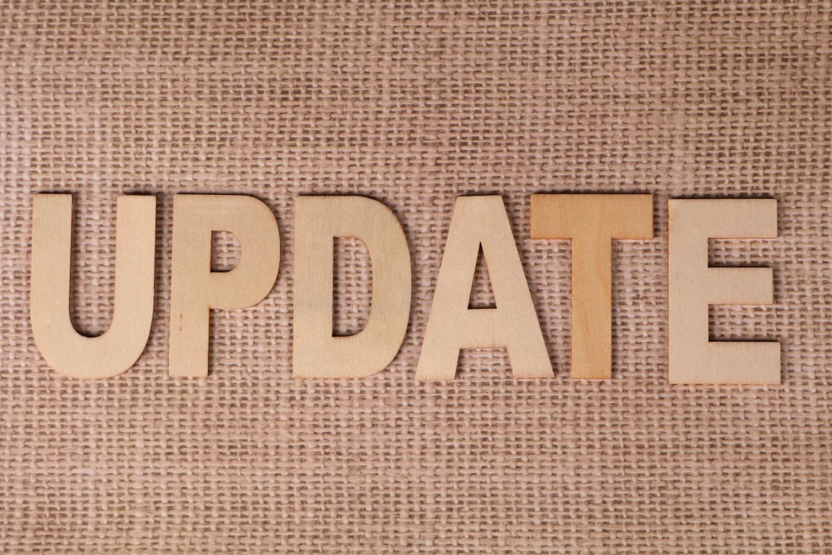 Wooden letters arranged to spell 'UPDATE' on a textured burlap surface, perfect business or project imagery. Wooden letters arranged to spell 'UPDATE' on a textured burlap surface, perfect business or project imagery.